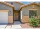 Close-up of a front exterior showing desert landscaping, secured entrance, and a view of the garage at 45391 W Portabello Rd, Maricopa, AZ 85139