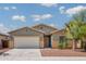 Charming single-story home with a two-car garage, desert landscaping, and a well-maintained lawn at 45391 W Portabello Rd, Maricopa, AZ 85139