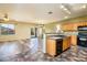 Bright kitchen featuring oak cabinets, modern appliances, and seamless flow to the dining area at 45391 W Portabello Rd, Maricopa, AZ 85139