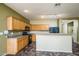 Spacious kitchen featuring wooden cabinets, sleek appliances, and an inviting breakfast bar at 45391 W Portabello Rd, Maricopa, AZ 85139