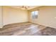 Inviting living room with wood-look flooring and large windows for ample natural light at 45391 W Portabello Rd, Maricopa, AZ 85139