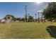 This well manicured back yard has a large grassy area with string lights, palm trees, and a structure at 5237 N 106Th Ave, Glendale, AZ 85307