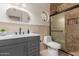 Stylish bathroom with a modern vanity, unique mirror, and walk-in shower at 5237 N 106Th Ave, Glendale, AZ 85307