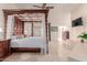 Spacious bedroom with a four-poster bed and neutral decor at 5237 N 106Th Ave, Glendale, AZ 85307