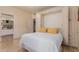 A bedroom with a white and blue murphy bed featuring yellow pillows and an attached bathroom at 5237 N 106Th Ave, Glendale, AZ 85307