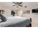 This bedroom features a ceiling fan, television and a large mirror closet at 5237 N 106Th Ave, Glendale, AZ 85307