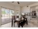Sunlit dining area with tile floors, wood table, and sliding glass doors to the outdoor space at 5237 N 106Th Ave, Glendale, AZ 85307