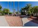 The front yard is nicely landscaped with a paved walkway and several palm trees at 5237 N 106Th Ave, Glendale, AZ 85307