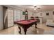 Spacious game room featuring a pool table and wet bar with travertine floors and sliding doors at 5237 N 106Th Ave, Glendale, AZ 85307