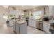 Well-lit kitchen with white cabinets, marble countertops, and modern appliances at 5237 N 106Th Ave, Glendale, AZ 85307