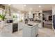 Kitchen area featuring a center island, built-in wine cooler, and stainless appliances at 5237 N 106Th Ave, Glendale, AZ 85307