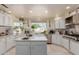 Bright kitchen with white cabinets, an island, and stainless steel appliances at 5237 N 106Th Ave, Glendale, AZ 85307