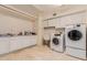 This laundry room features a washer, dryer, utility sink, counters and cabinet storage at 5237 N 106Th Ave, Glendale, AZ 85307