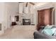 Open-concept living room with fireplace, accent wall, and furniture at 5237 N 106Th Ave, Glendale, AZ 85307
