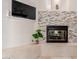 Cozy living room features a stone fireplace, mounted television, and stylish decor at 5237 N 106Th Ave, Glendale, AZ 85307