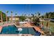 Enjoy this backyard featuring a pool, palm trees, spa, and beautiful landscaping at 5237 N 106Th Ave, Glendale, AZ 85307