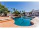 Backyard pool with a diving board, surrounded by lush landscaping, offering a private outdoor oasis for relaxation at 5237 N 106Th Ave, Glendale, AZ 85307