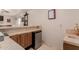 Modern wet bar featuring a granite countertop, wooden cabinets, mini-fridge and a sink at 5237 N 106Th Ave, Glendale, AZ 85307