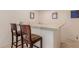 Wet bar with seating and light countertop, perfect for entertaining or a relaxing evening at home at 5237 N 106Th Ave, Glendale, AZ 85307
