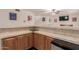 Cozy wet bar featuring a serving area with wooden cabinets and a mini-fridge for entertaining at 5237 N 106Th Ave, Glendale, AZ 85307