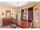 Dining room features a chandelier, large table with ornate chairs and cabinet at 5314 W Bowker St, Laveen, AZ 85339