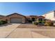 Inviting exterior view of a single-story home with gravel landscaping and a well-maintained lawn at 5314 W Bowker St, Laveen, AZ 85339