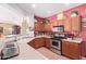 Warm kitchen showcasing countertops, stainless steel appliances, and wooden cabinets at 5314 W Bowker St, Laveen, AZ 85339