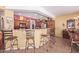 Open kitchen and bar area with barstool seating and wooden cabinetry at 5314 W Bowker St, Laveen, AZ 85339