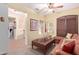 Cozy living room with plush leather seating, ottoman, and a decorative ceiling fan at 5314 W Bowker St, Laveen, AZ 85339