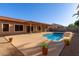 Inviting backyard pool area with lounge chairs, landscaped surroundings, and a clear blue pool at 5314 W Bowker St, Laveen, AZ 85339