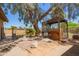Backyard area featuring wooden pergola and mature landscaping at 6329 E Voltaire Ave, Scottsdale, AZ 85254