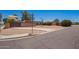 Property on a corner lot with desert landscaping, an iron gate, and a covered parking area at 6329 E Voltaire Ave, Scottsdale, AZ 85254