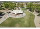 Aerial view of community park with playground equipment, shade structures, and well-maintained lawns at 6922 S Black Hills Way, Chandler, AZ 85249