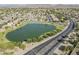 An aerial view of a neighborhood showcasing a serene lake and picturesque mountain backdrop at 6922 S Black Hills Way, Chandler, AZ 85249