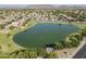An aerial view of a neighborhood showcasing a serene lake and picturesque mountain backdrop at 6922 S Black Hills Way, Chandler, AZ 85249