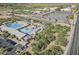 Aerial view of community pool with water slides, swimming area, and ample parking at 6922 S Black Hills Way, Chandler, AZ 85249