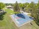 Aerial view of community park with a basketball court surrounded by green lawns and trees at 6922 S Black Hills Way, Chandler, AZ 85249