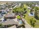 An aerial view shows a landscaped backyard with a pool, green space, a patio, and solar panels at 6922 S Black Hills Way, Chandler, AZ 85249