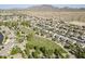 Aerial view of homes in community situated near a scenic green park with walking paths at 6922 S Black Hills Way, Chandler, AZ 85249