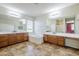 Primary bathroom with soaking tub, double sink vanity, and tile floor at 6922 S Black Hills Way, Chandler, AZ 85249