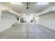 Spacious three-car garage featuring overhead storage racks and ample room for parking at 6922 S Black Hills Way, Chandler, AZ 85249