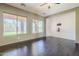 Living room featuring hardwood floors, two large windows, and wall mounts for a TV at 6922 S Black Hills Way, Chandler, AZ 85249