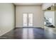 Bright, open-concept living room featuring modern dark wood flooring and doors to the outside patio at 6922 S Black Hills Way, Chandler, AZ 85249
