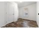 Bright bedroom with a window and a door, featuring modern wood-look flooring at 701 S Dobson Rd # 447, Mesa, AZ 85202