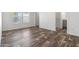 This bright bedroom features wood-look flooring and an ensuite bath at 701 S Dobson Rd # 447, Mesa, AZ 85202