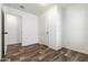 Empty bedroom showcasing new flooring, a white door, and freshly painted walls at 701 S Dobson Rd # 447, Mesa, AZ 85202