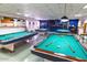 An inviting billiards room with multiple tables set up for play, with cues and balls ready at 701 S Dobson Rd # 447, Mesa, AZ 85202