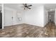 Open living room with durable flooring, a ceiling fan, and a welcoming front door at 701 S Dobson Rd # 447, Mesa, AZ 85202