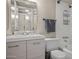 Well-lit bathroom featuring a sink with vanity, toilet, and shower with shelving at 735 E Cochise Dr, Phoenix, AZ 85020