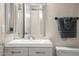 Bright bathroom featuring a sink with vanity and a mirrored wall reflecting a doorway at 735 E Cochise Dr, Phoenix, AZ 85020